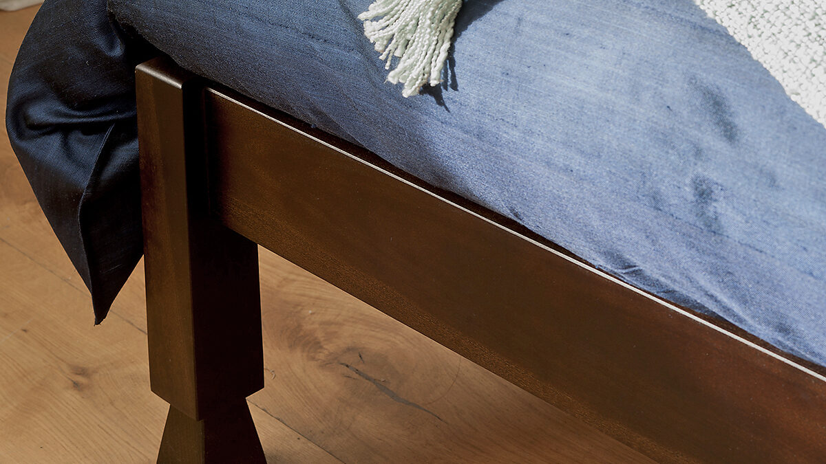 A close up photo showing the Samarkand bed carved wooden leg detail