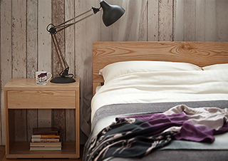 A rustic bedroom look featuring an ash wood Malabar bed and Cube Bedside table.