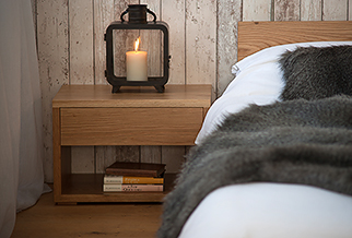 A rustic bedroom look simple Oak low Cube bedside table with storage drawer and open bookshelf..