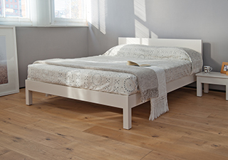 A white painted Sahara wooden bed and bedside table