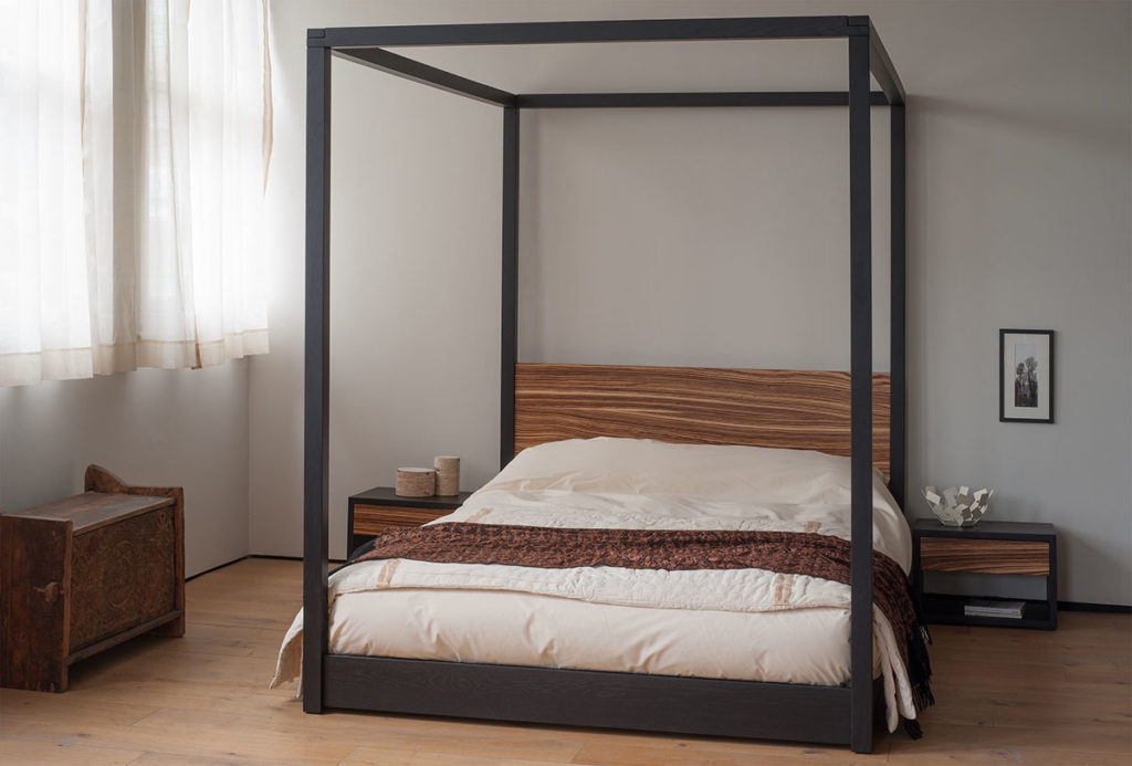 Cube low solid wood 4 poster bed in black oak and Zebrano wood.