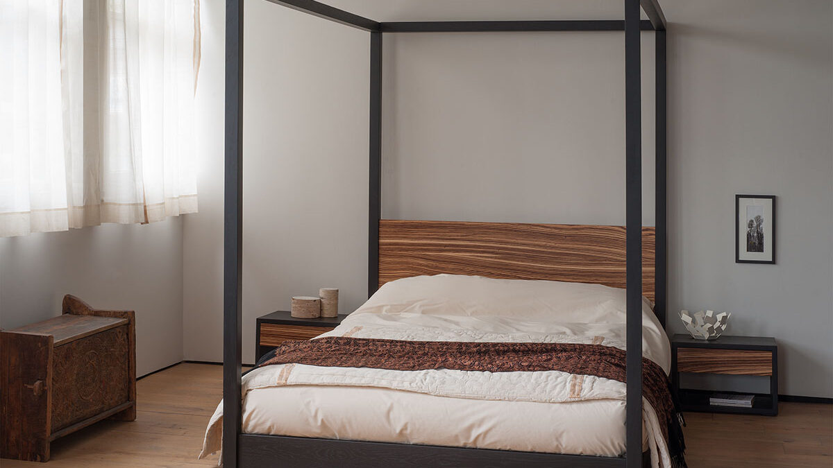 Cube low solid wood 4 poster bed in black oak and Zebrano wood.