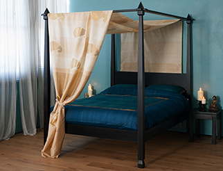 Our Raj wooden 4 poster bed has tapering posts and carved details