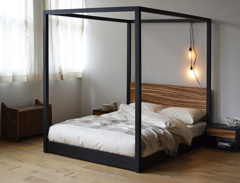 Low contemporary Cube 4 poster bed in bespoke Zebrano wood and black Oak.