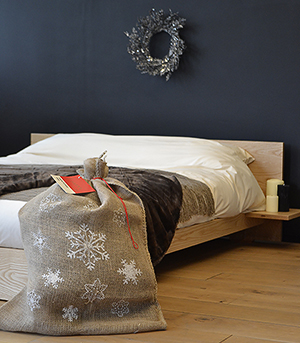 Kulu low wooden bed with Santa sack