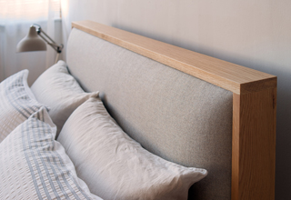 Modern oak bed with upholstered headboard