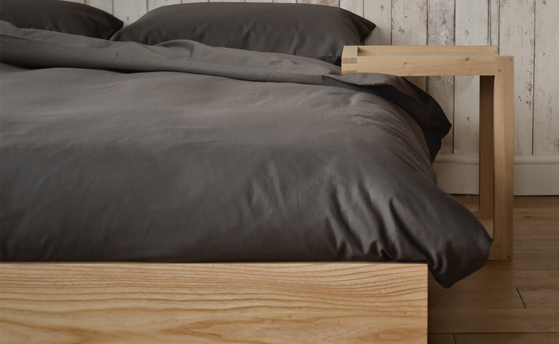 Ki ultra low wooden bed made from solid Ash & shown with Frame bedside table