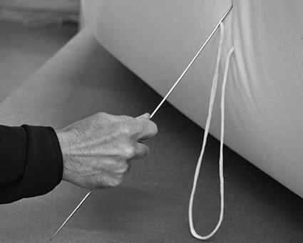 Futon making - our hand made futon mattresses being threaded at our British workshop.