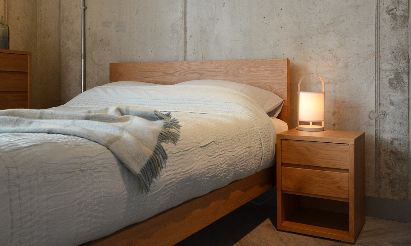 Oak 2 drawer bedside Cube Table shown with our Oak Malabar Bed