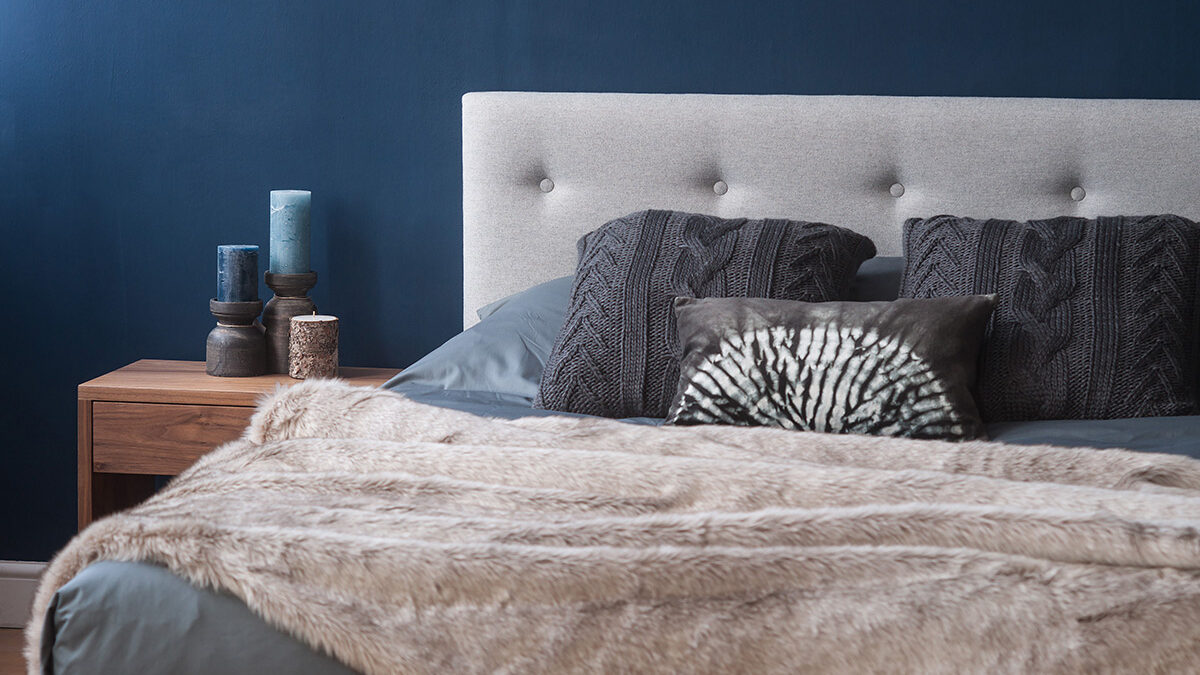 Arran smoke grey bedding and beige faux fur throw