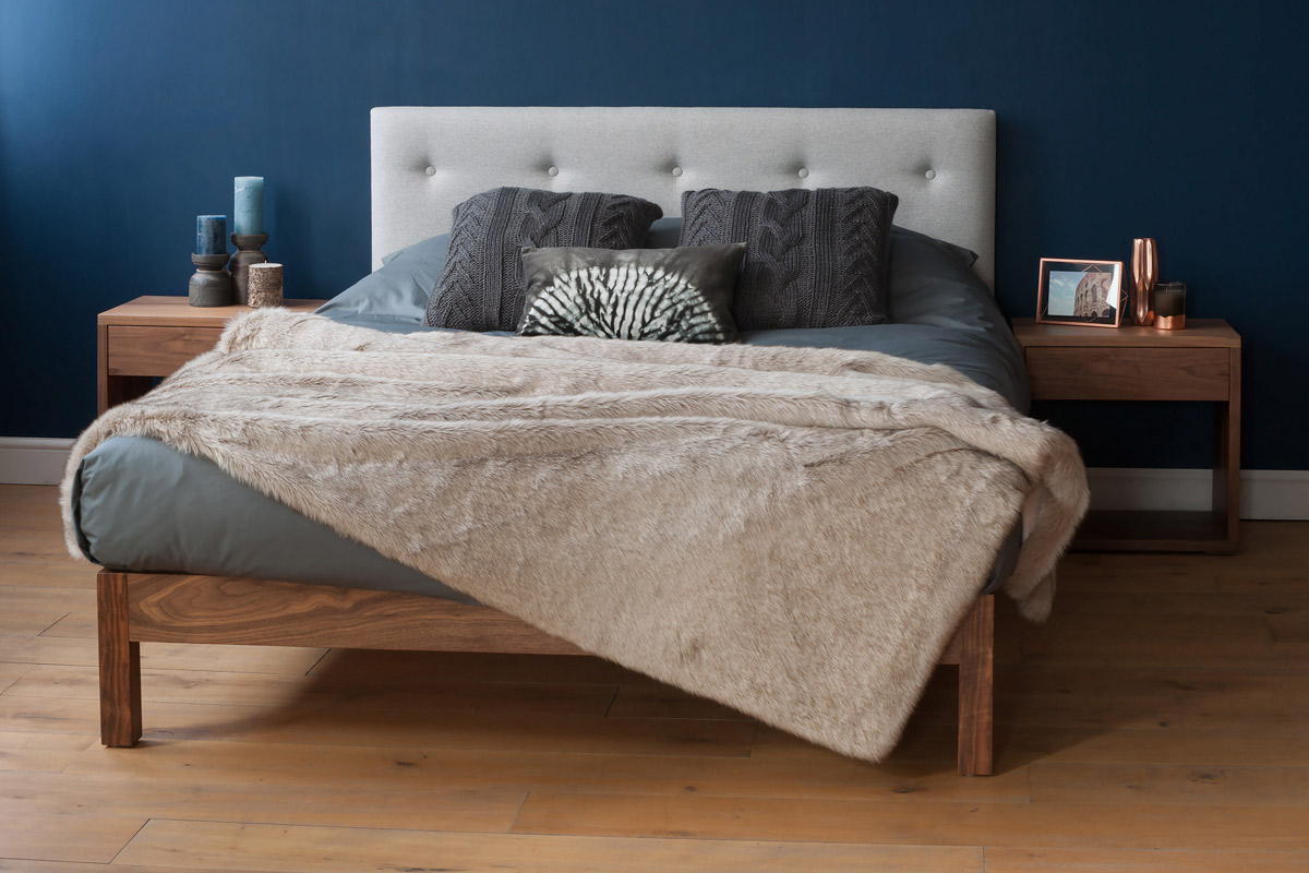 Arran bed with upholstered headboard in grey wool fabric and a walnut frame