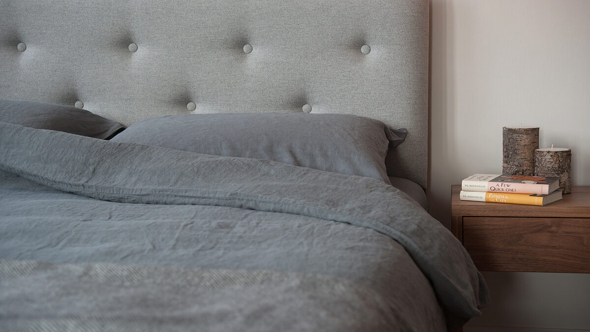 buttoned headboard bed with linen bedding