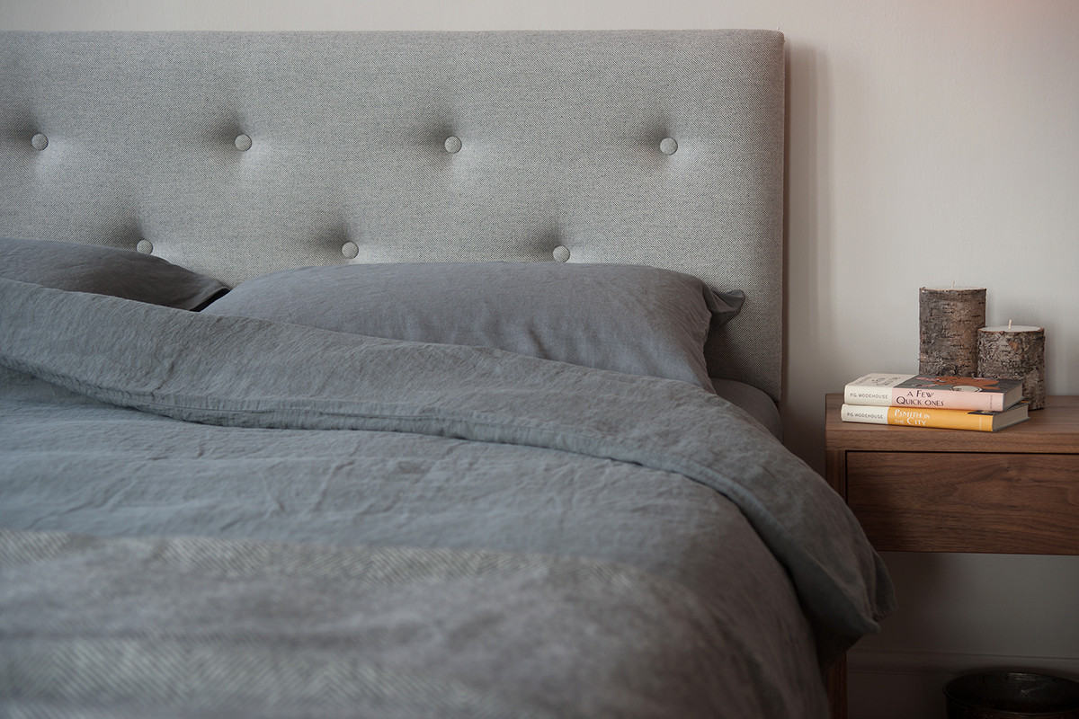 buttoned headboard bed with linen bedding