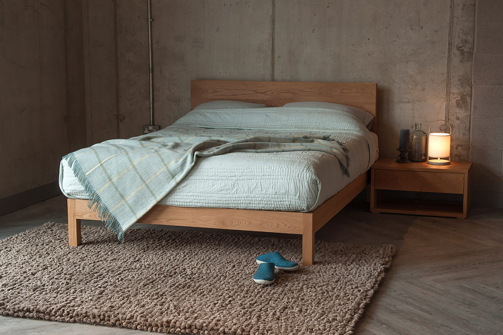 Contemporary solid wood Malabar bed with Cube bedside table all in Oak.