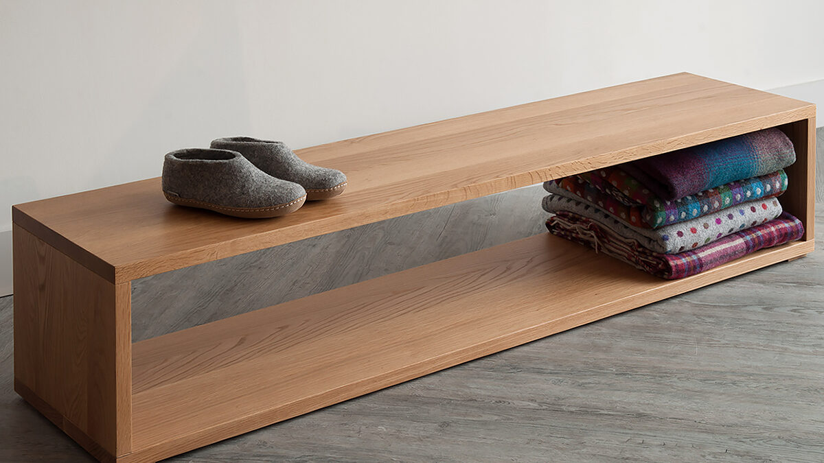 An Oak end of bed wooden storage bench by Black Lotus for natural bed company