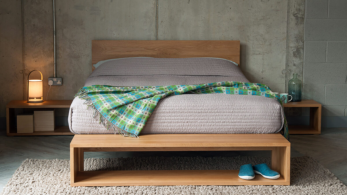 Cube open shelf tables as end-of-bed storage and bedsides all in Oak.