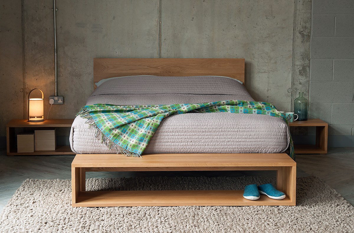 Cube open shelf tables as end-of-bed storage and bedsides all in Oak.