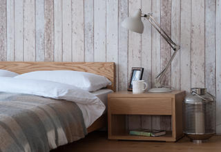 Contemporary Scandinavian Style Bedroom with low solid wood bed and bedside table.