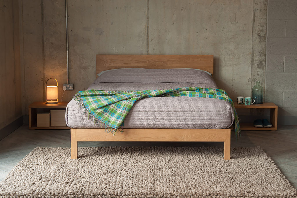 Contemporary Oak Malabar bed with Black Lotus open Cube bedside tables.