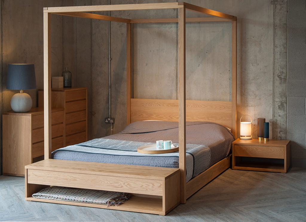 Industrial bedroom look with warm Oak furniture. Cube 4 Poster bed is the centrepiece, with Cube collection chests and an end of bed bench.