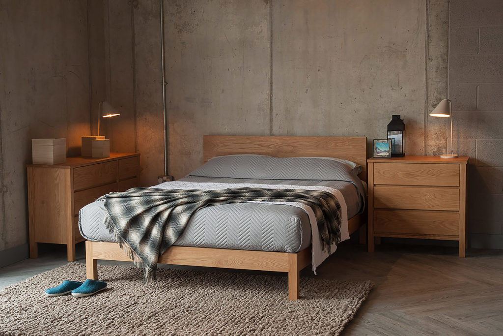 Industrial look bedroom with solid Oak Malabar bed, Oak storage drawers and grey bedding.