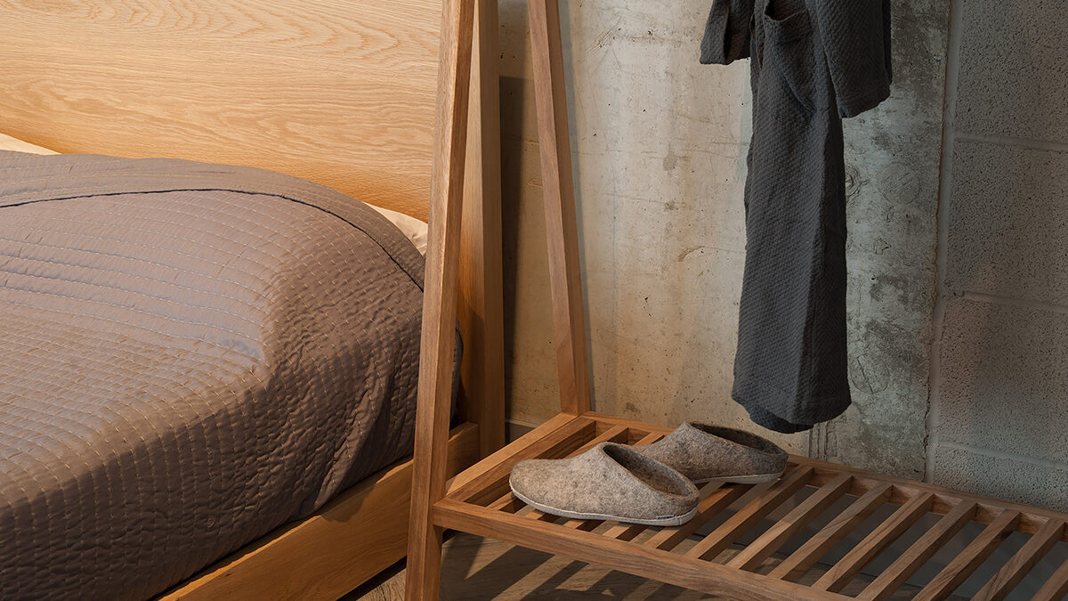 A view of the slatted shelf of the wooden clothes hanging rail