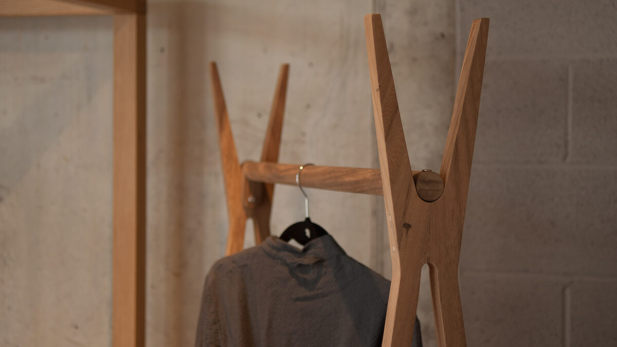 A closer view of the wooden clothes hanging rail