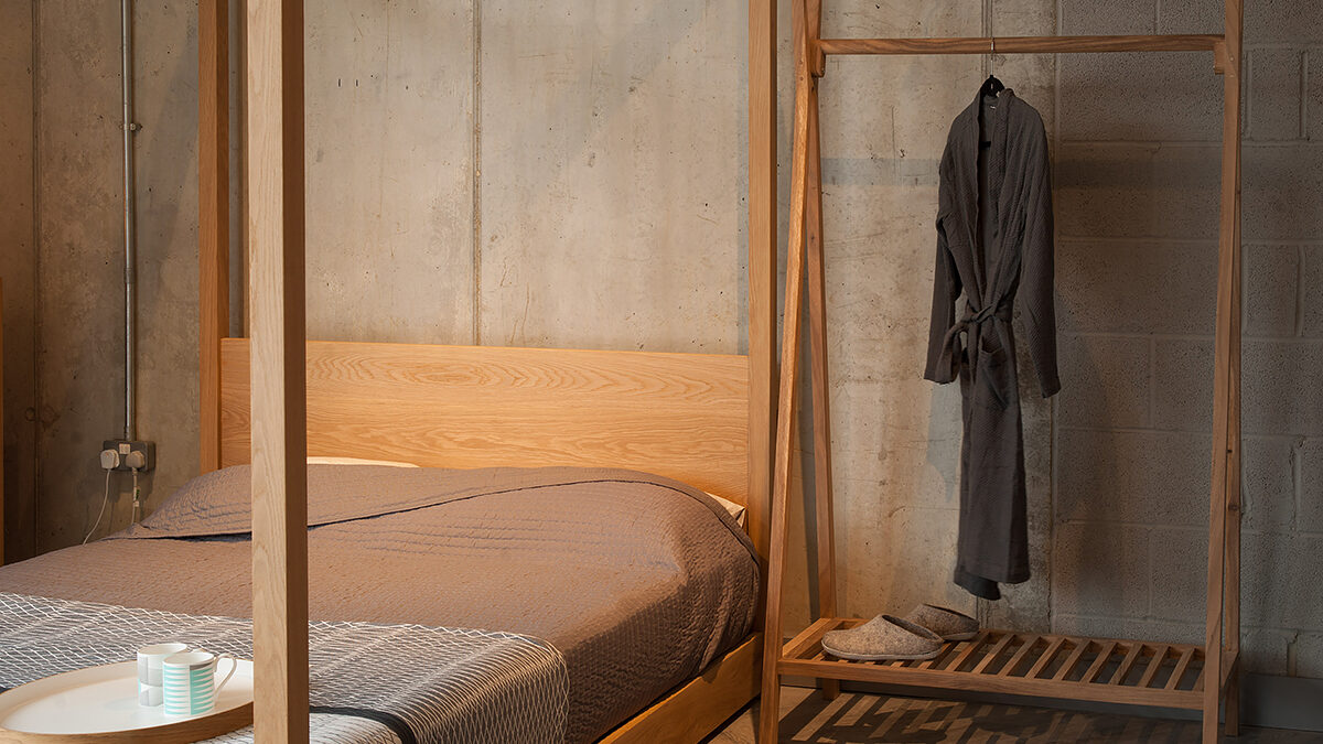 Wooden clothes rail with shelf next to our Cube 4 Poster Bed