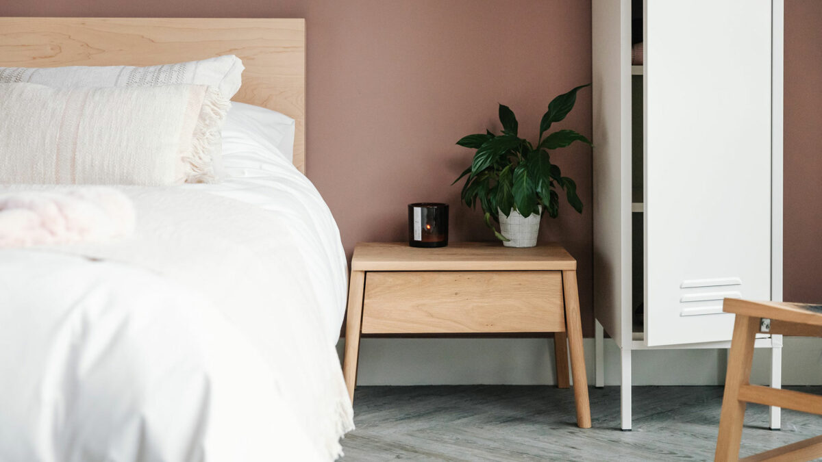 Air bedside table with drawer in oak and shown with Maple Malabar bed