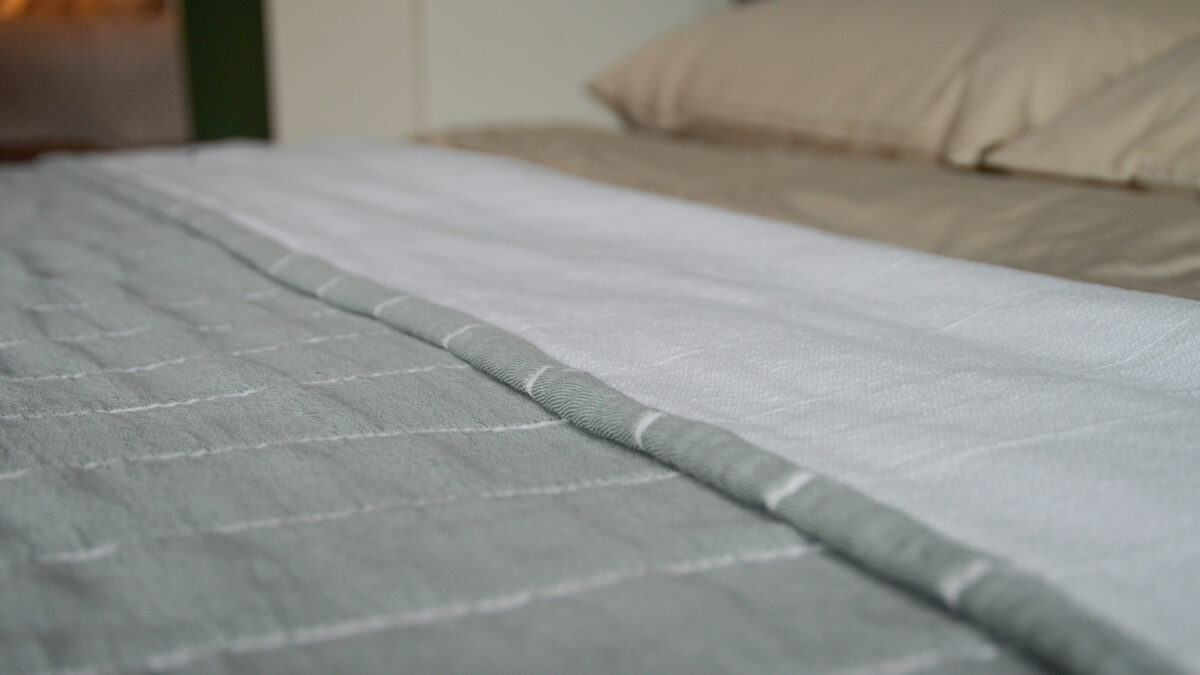 Jade green striped cotton bedspread showing the reverse