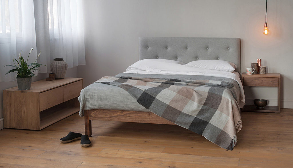 A cosy Scandi style bedroom featuring a Walnut Arran bed with Bedside Cube Table also in Walnut