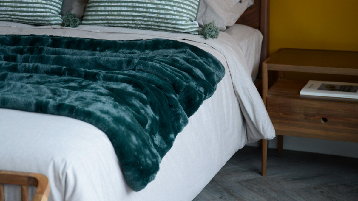 soft and luxurious faux fur throw in forest green