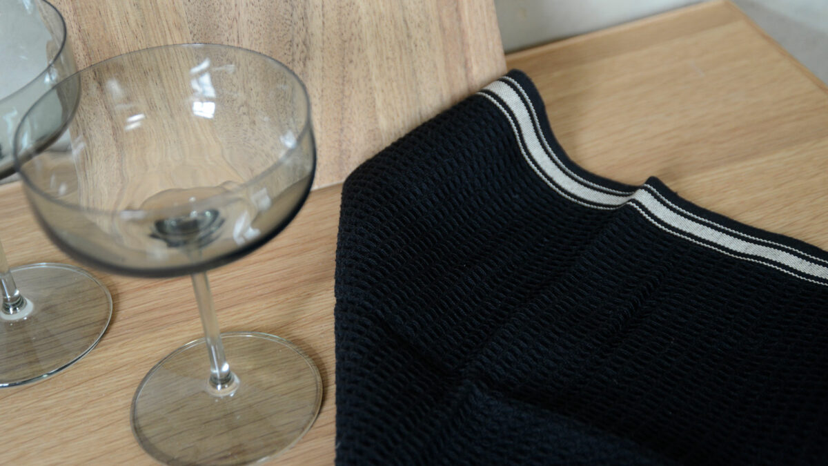 Black Beige Dishcloth with Champagne Glasses and Walnut Chopping Boards