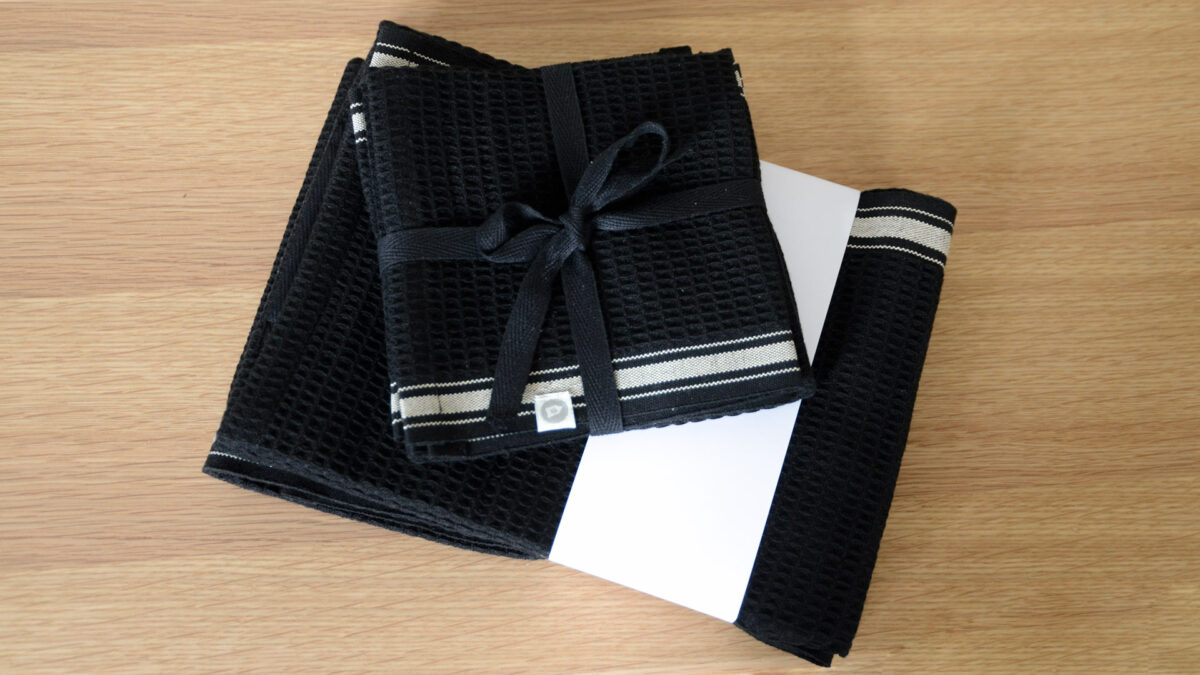 Black Beige Dishcloths and Teal Towels on Oak Wireworks Bench