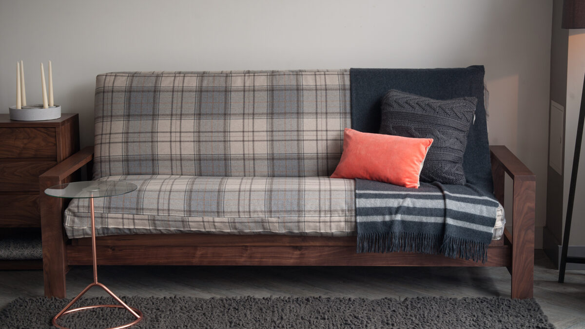 Black Lotus cuba futon sofa-bed with a wool loose cover and in Walnut