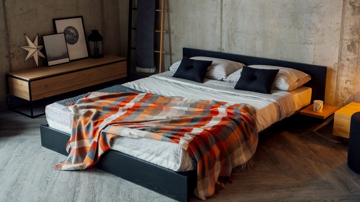 Kulu is a low solid wood bed with optional attached side tables. The painted bed frame has contrasting tables in Oak.