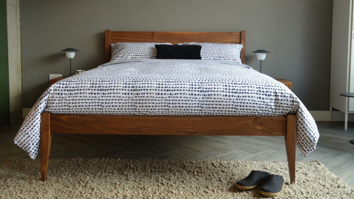 Monochrome abstract print duvet cover set shown on our walnut wood Cochin bed