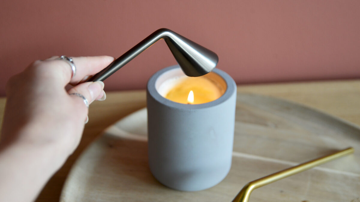 Blomus Candle Snuffers in hand with lit candle