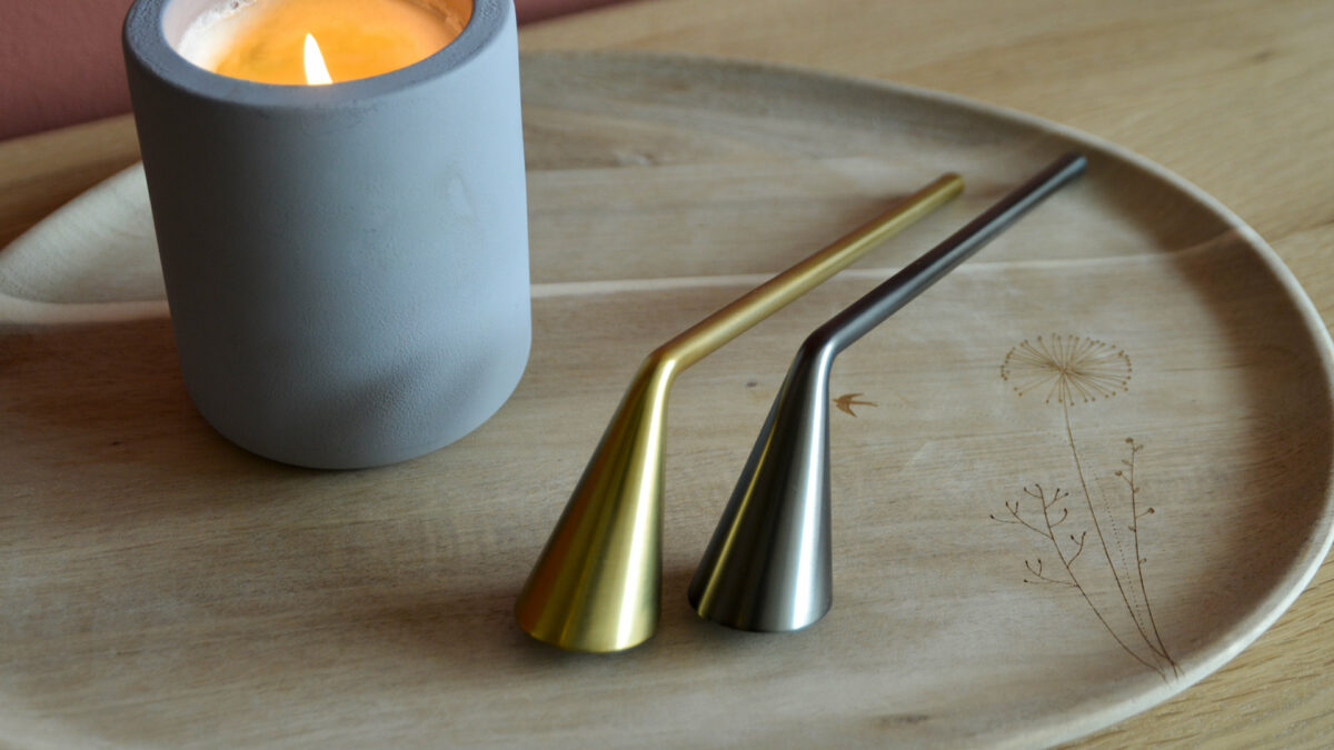Blomus Candle Snuffers on tray with lit candle