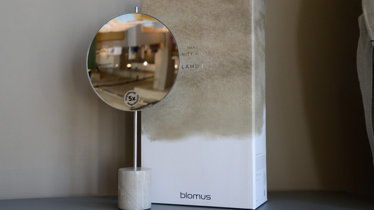 Adjustable height magnifying mirror with marble base shown with its box