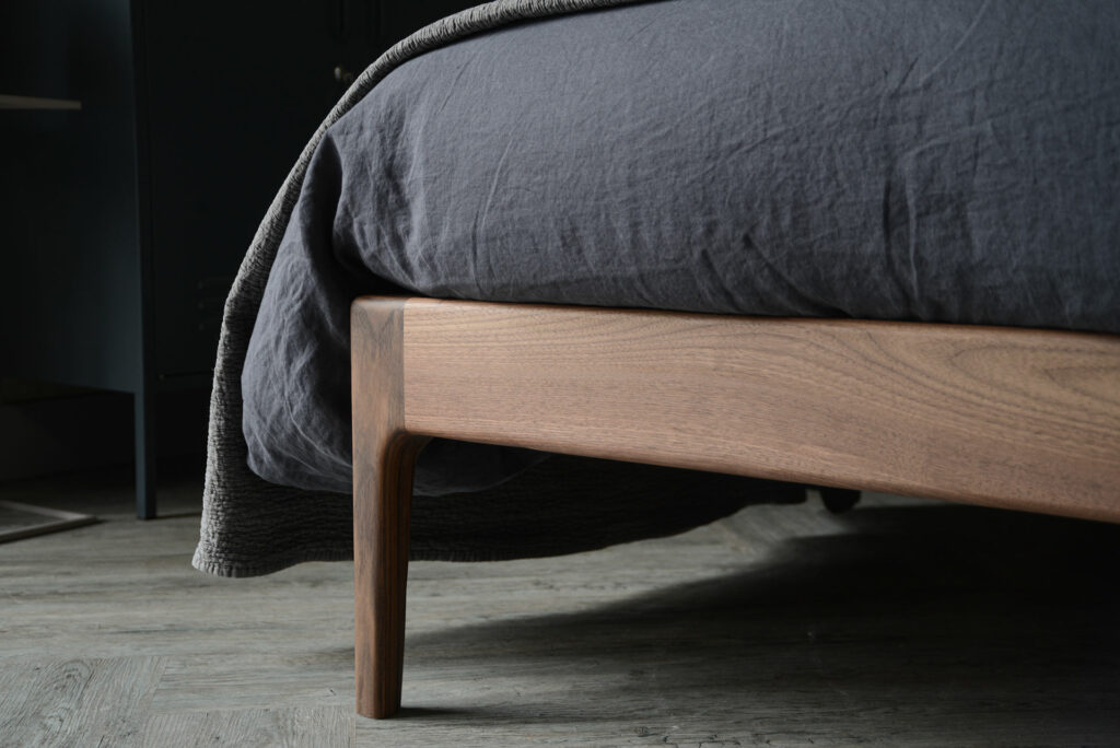 A closer view of the solid wood Bloomsbury bed leg, here in solid walnut