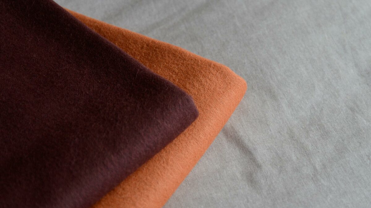 90% recycled Alpaca/wool mix throws in orange or plum