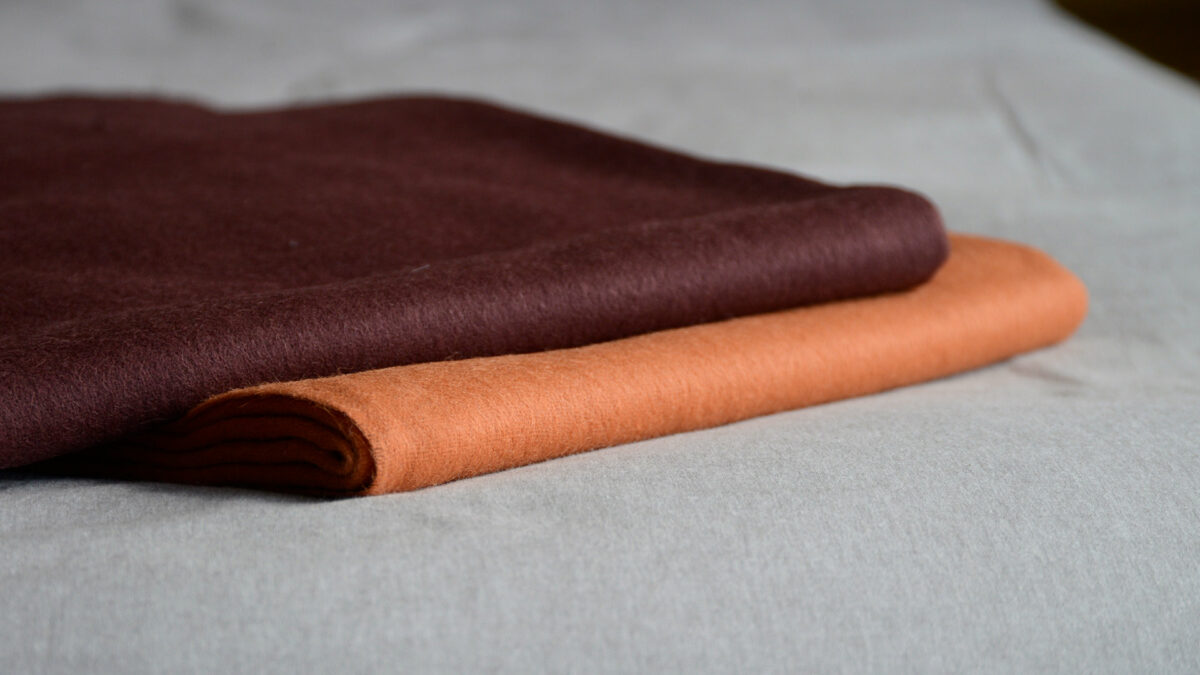 90% recycled Alpaca/wool mix throw in orange or plum