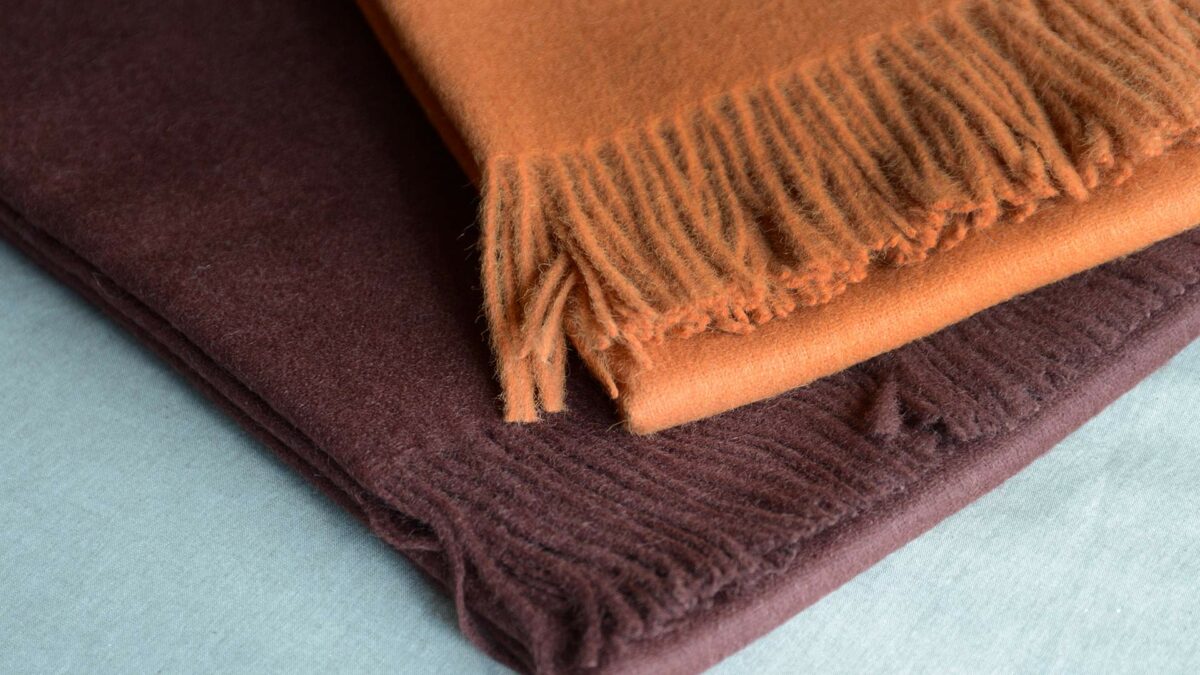 90% recycled Alpaca/wool mix throw in orange or plum