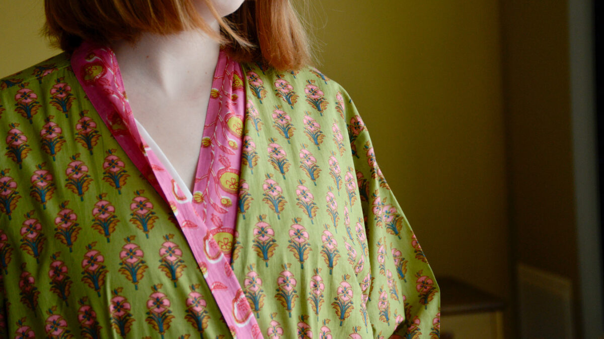 Image showing closeup detail of pattern on green and pink floral robe with bright pink trim.