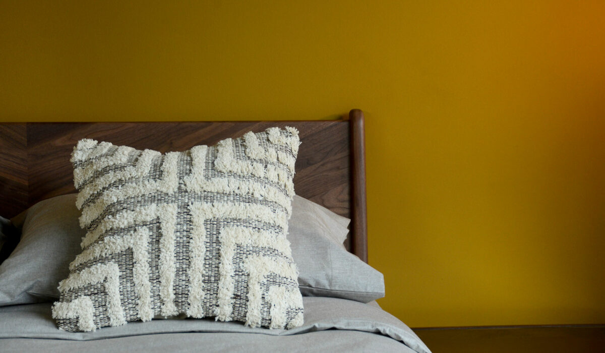 Tufted and textured cotton cushion in a brown and cream design