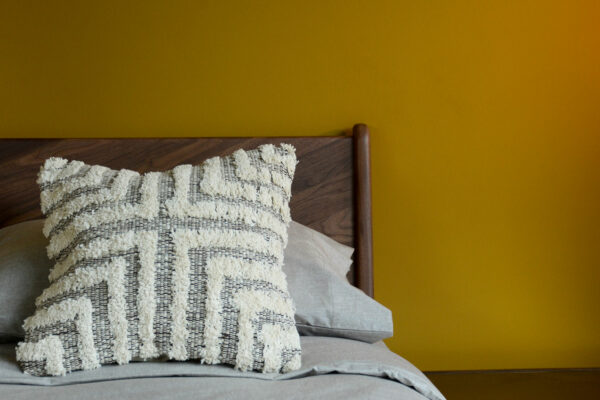 Tufted and textured cotton cushion in a brown and cream design