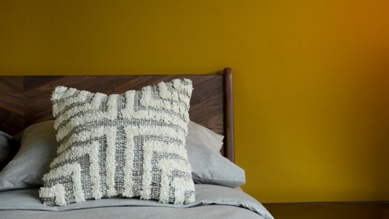 Brown Cream Tufted Cross Cushion on Walnut Hoxton