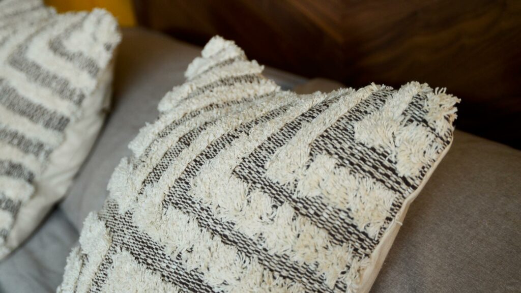 Tufted and textured cotton cushions in a brown and cream design