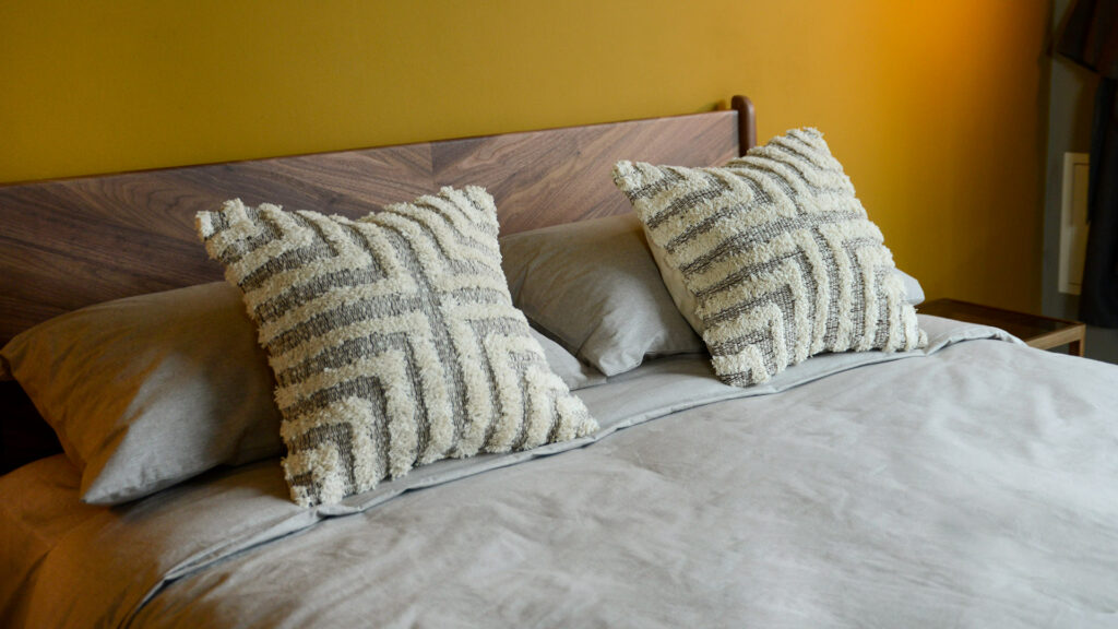 Tufted and textured cotton cushions in a brown and cream design